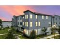 Beautiful townhouse showcasing modern architecture with picturesque sunset backdrop at 12468 Koshiba Aly, Orlando, FL 32827