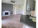 Open-concept living room with modern fireplace, seamless transition to the kitchen area at 152 Glendale Ct, Kissimmee, FL 34759