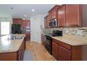 Spacious kitchen with wood cabinets, stainless steel appliances, and a stylish backsplash at 1588 Diamond Loop Drive, Kissimmee, FL 34744