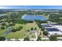 Panoramic aerial view showcases the property's location with lake access and sprawling greenery at 17927 E Apshawa Rd, Minneola, FL 34715