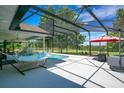 Backyard pool with outdoor seating, umbrella, grill, and a view at 17927 E Apshawa Rd, Minneola, FL 34715