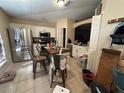 Eat-in kitchen featuring tile flooring, stainless steel appliances, and white cabinetry at 1909 Lakeview Pl, Kissimmee, FL 34759