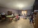 Spacious living room with tile flooring, chandelier lighting, and backyard views at 1909 Lakeview Pl, Kissimmee, FL 34759