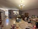 Spacious living room featuring tile flooring, chandelier lighting, and an open plan at 1909 Lakeview Pl, Kissimmee, FL 34759