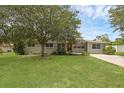 Charming single-story home featuring a brick exterior, mature landscaping, and a well-manicured lawn at 203 E Lakeview Ave, Eustis, FL 32726