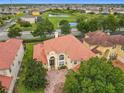 An eye-level view of a home with a tile roof and manicured lawn at 2209 Callaway Ct, Davenport, FL 33837