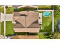 Aerial view of a home with a pool, patio, and well-maintained landscaping at 2235 Meadowmouse St, Orlando, FL 32837