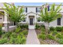 Attractive townhome with beautiful landscaping, a brick walkway, and a charming entrance, enhancing curb appeal at 3099 Ella Way, St Cloud, FL 34771