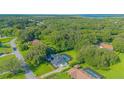 An aerial view of the home nestled among trees with a pool and screened enclosure at 3160 Whisper Wind Dr, St Cloud, FL 34771