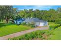 Beautiful white home with lush landscaping and a well-maintained lawn at 3160 Whisper Wind Dr, St Cloud, FL 34771