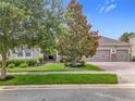 Single-story home with well manicured lawn and landscaping plus brick paved driveway at 31980 Geoff Way, Sorrento, FL 32776
