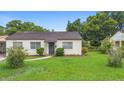 Inviting home featuring a well-manicured lawn and pathway leading to the front door, perfect for curb appeal at 3702 Starks St, Orlando, FL 32805