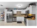 Updated kitchen boasting stainless steel appliances, tile backsplash, and ample storage space at 3702 Starks St, Orlando, FL 32805
