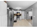 Well-lit kitchen featuring stainless steel appliances, white cabinets, and tile flooring throughout at 3702 Starks St, Orlando, FL 32805