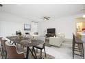 Open-concept living room and dining area with tile floors and bright, neutral decor at 3782 Sw 130Th Loop, Ocala, FL 34473