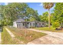 Exterior view of the home with driveway, chain-link fence and backyard at 414 W 19Th St, Sanford, FL 32771