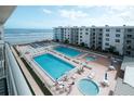 Inviting community pools and lounging area with ocean view at 4151 S Atlantic Ave # 5110, New Smyrna Beach, FL 32169