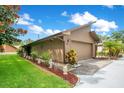 The home's exterior with well-manicured landscaping and a large two-car garage at 545 Mystic Wood St, Casselberry, FL 32707