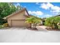 Spacious garage and driveway with mature palm trees adding to the curb appeal at 545 Mystic Wood St, Casselberry, FL 32707