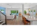 Open-concept living area with hardwood floors, modern furnishings, and views of the backyard pool at 617 Worthington Dr, Winter Park, FL 32789