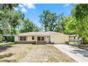 Charming single-story home with a well-maintained lawn and attached two car garage at 710 N Sparkman Ave, Orange City, FL 32763
