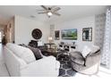 Spacious living room featuring stylish furniture, ceiling fan, and lots of natural light at 8982 Cabot Cliffs Dr, Davenport, FL 33896