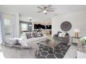 Spacious living room featuring stylish furniture, ceiling fan, and lots of natural light at 8982 Cabot Cliffs Dr, Davenport, FL 33896