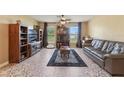 Cozy living room featuring tile floors, a ceiling fan, and bright windows at 929 Louvre Ct, Kissimmee, FL 34759