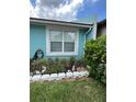 Landscaping detail with decorative bunnies and bright yellow flowering bush at 976 Alicante Ave, Orlando, FL 32807