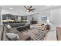Bright, open-concept living area featuring tile flooring, modern furnishings and views to the kitchen at 1224 Hillcrest View Loop, Apopka, FL 32703