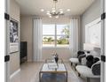 Cozy living room with ample natural light, elegant furnishings, and a view of the outdoors at 13521 Pearl Beach St, Winter Garden, FL 34787