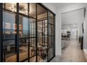 Bright hallway featuring glass-walled office, and an open view to the modern kitchen and living spaces at 15133 Summer Harvest St, Winter Garden, FL 34787