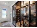 Modern office space with stylish glass walls, built-in shelving, and a sophisticated design at 15133 Summer Harvest St, Winter Garden, FL 34787