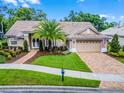Well-maintained home with a tile roof, two-car garage, and beautiful landscaping enhances its exterior appeal at 174 Promenade Cir, Lake Mary, FL 32746