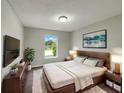 Comfortable bedroom features neutral walls, wood furniture and a window with plenty of natural light at 1793 Western Hills Ln # N, Mascotte, FL 34753
