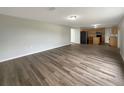 Spacious living room featuring an open layout and wood flooring, seamlessly connected to the kitchen at 1793 Western Hills Ln # N, Mascotte, FL 34753