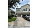 Suburban townhouse boasts a well-kept lawn, attached garage, and an upper balcony at 1984 Estancia Circle # 29A, Kissimmee, FL 34741