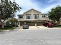 Attractive townhouses boast welcoming curb appeal with private garages and balconies at 1984 Estancia Circle # 29A, Kissimmee, FL 34741