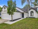 A lovely one-story home features a manicured lawn, well maintained landscaping, and charming curb appeal at 2160 Churchill Downs Cir, Orlando, FL 32825