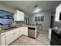 Modern kitchen with white cabinets, stainless steel appliances, granite countertops, and wood flooring at 258 Magellan Dr, Kissimmee, FL 34758