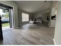 Bright living room with wood floors, vaulted ceilings, and comfortable seating, open to the kitchen at 258 Magellan Dr, Kissimmee, FL 34758