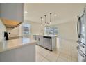 Modern kitchen featuring stainless steel appliances and gray cabinets at 2601 Blowing Breeze Ave, Kissimmee, FL 34744