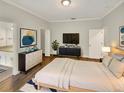 Bright main bedroom with wood floors, modern furnishings, and ensuite bathroom access at 2679 Rainbow Springs Ln, Orlando, FL 32828
