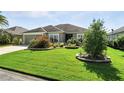 Charming home showcasing lush green lawn and beautiful landscaping at 2895 Apache Ct, The Villages, FL 32163