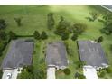 An aerial view shows this home nestled in a peaceful neighborhood with well-manicured lawns at 30210 Donnington Loop, Mount Dora, FL 32757