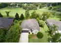 An aerial view of the property with a well-maintained lawn and landscaping, in a quiet neighborhood at 30210 Donnington Loop, Mount Dora, FL 32757