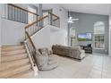 Bright living room featuring high ceilings, large windows, neutral paint, and a staircase to second story at 333 Sonoma Valley Cir, Orlando, FL 32835