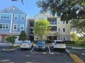 Exterior of a multi-story condo building with neat landscaping and assigned parking at 3446 Soho St # 108, Orlando, FL 32835