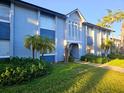 Two-story condominium exterior featuring light blue paint and lush landscaping at 4701 S Texas Ave # 4701A, Orlando, FL 32839