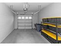 Clean two-car garage with epoxy flooring and ample storage space, showcasing functionality and organization at 4733 Cliveden Loop, Sanford, FL 32773